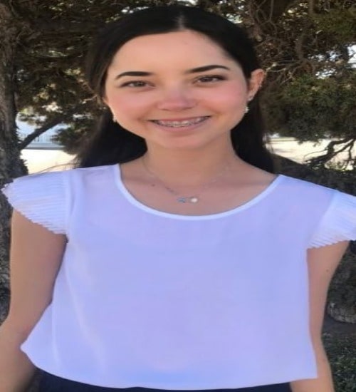 Picture of Marisol Yotta during her early age posing for a photoshoot wearing white t - shirt